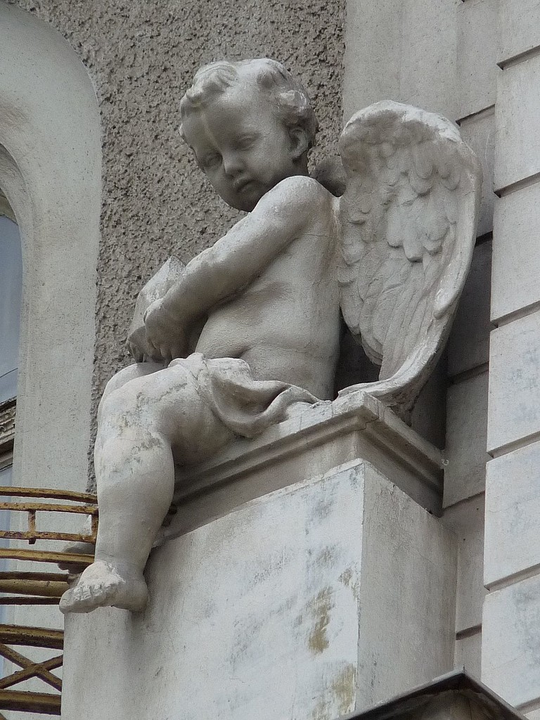 An angel with nice wings sitting on the edge of a balcony. by kclaire