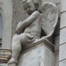 An angel with nice wings sitting on the edge of a balcony. by kclaire