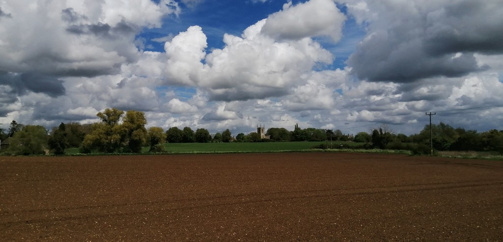 Church, clouds and a field by dragey74