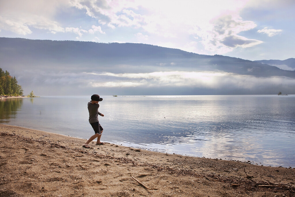 Skipping stones on the lake by kiwichick