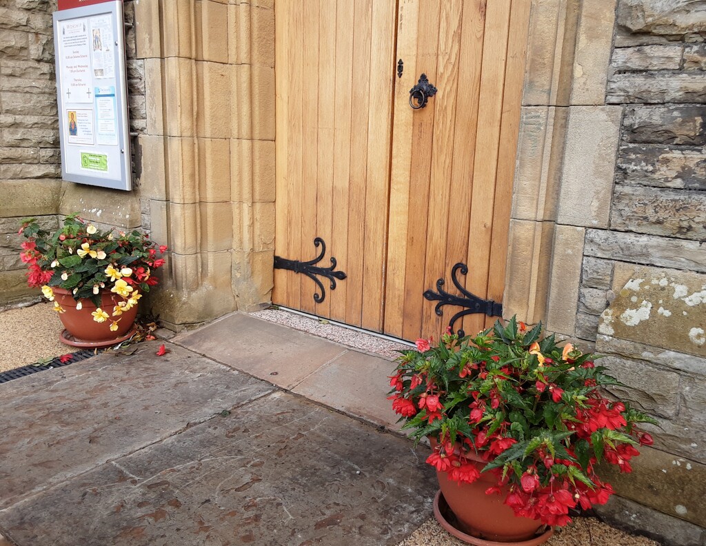 Flower planters beside the Church door. by grace55