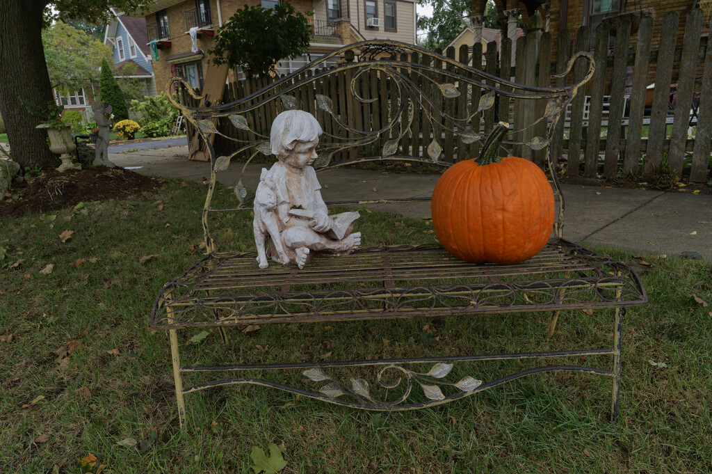 Statue with pumpkin on a bench by rminer