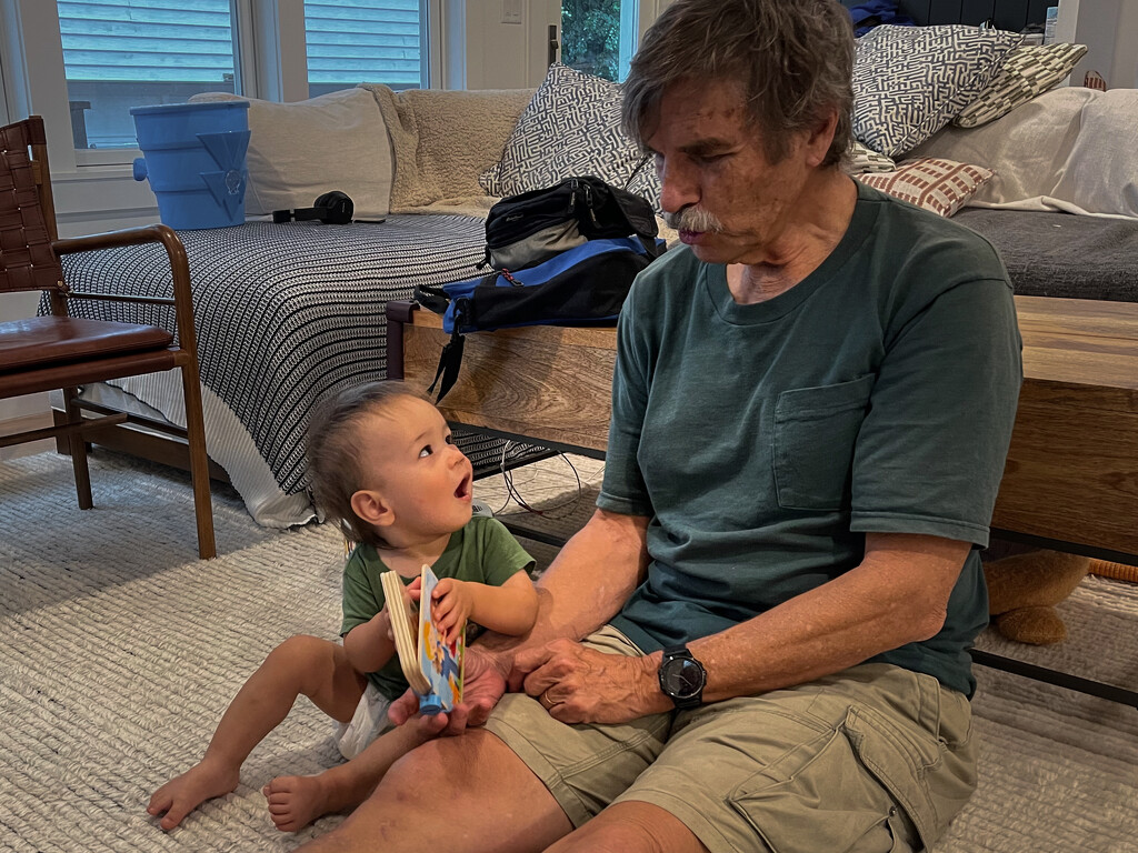 Pop-Pop reading to grandson by jbritt