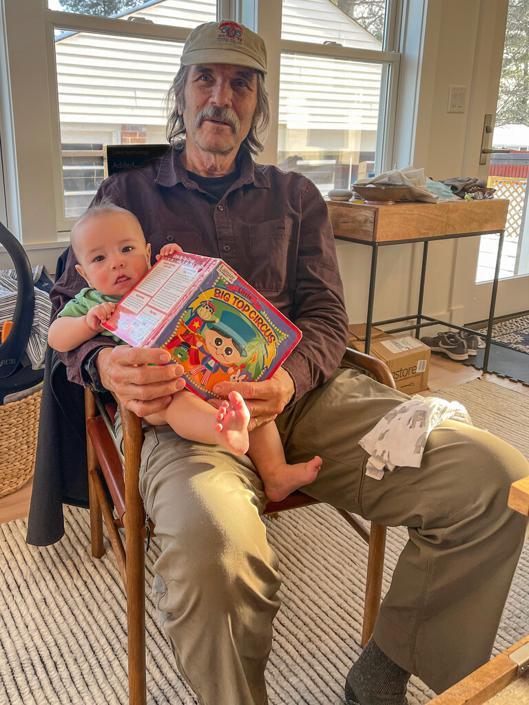 Grandpa and grandson reading together by jbritt