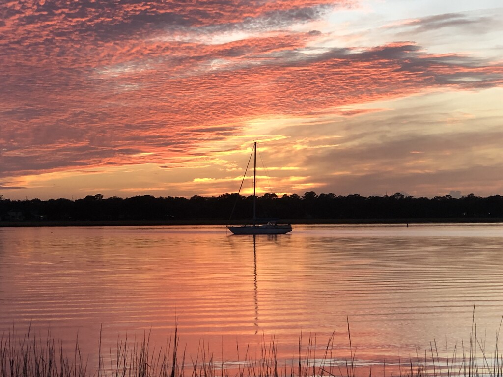 Sunset with sailboat on the river! by congaree
