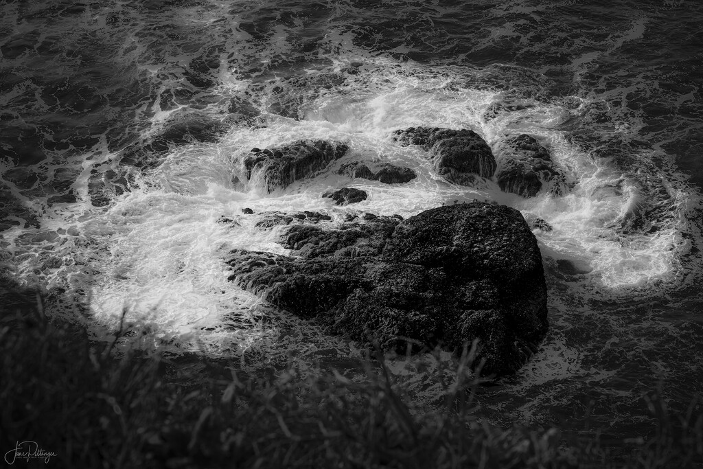 Black and White Swirls Around Rock  by jgpittenger