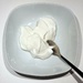 Yogurt in a white bowl on a white background by thedarkroom