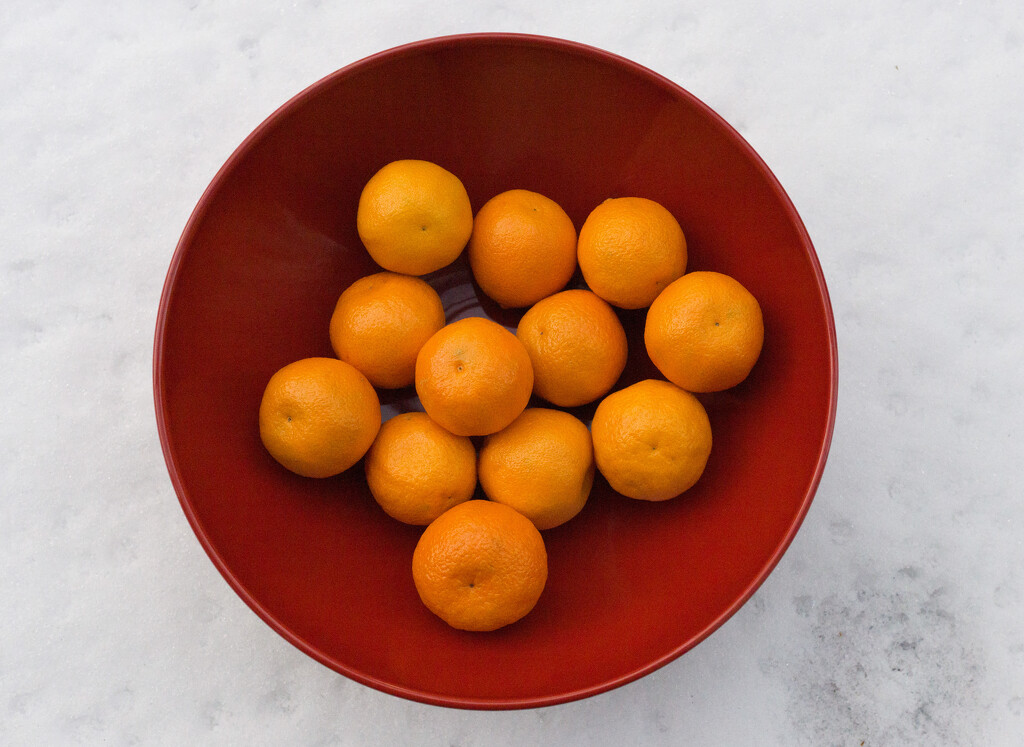 Mandarin oranges in a red bowl for good luck in 2022 by cristinaledesma33