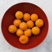 Mandarin oranges in a red bowl for good luck in 2022