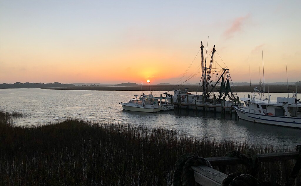 Sunset over distant fog-shrouded marsh by congaree