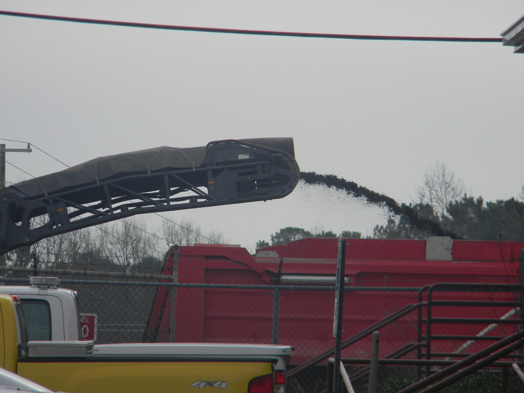 Truck Pouring Asphalt in Parking Lot by sfeldphotos