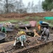 Dinosaurs in the mud kitchen by roachling