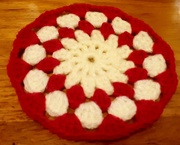 18th Feb 2022 - A red and cream crocheted flower coaster.