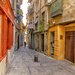 Colorful street in Toledo, Spain by ggshearron