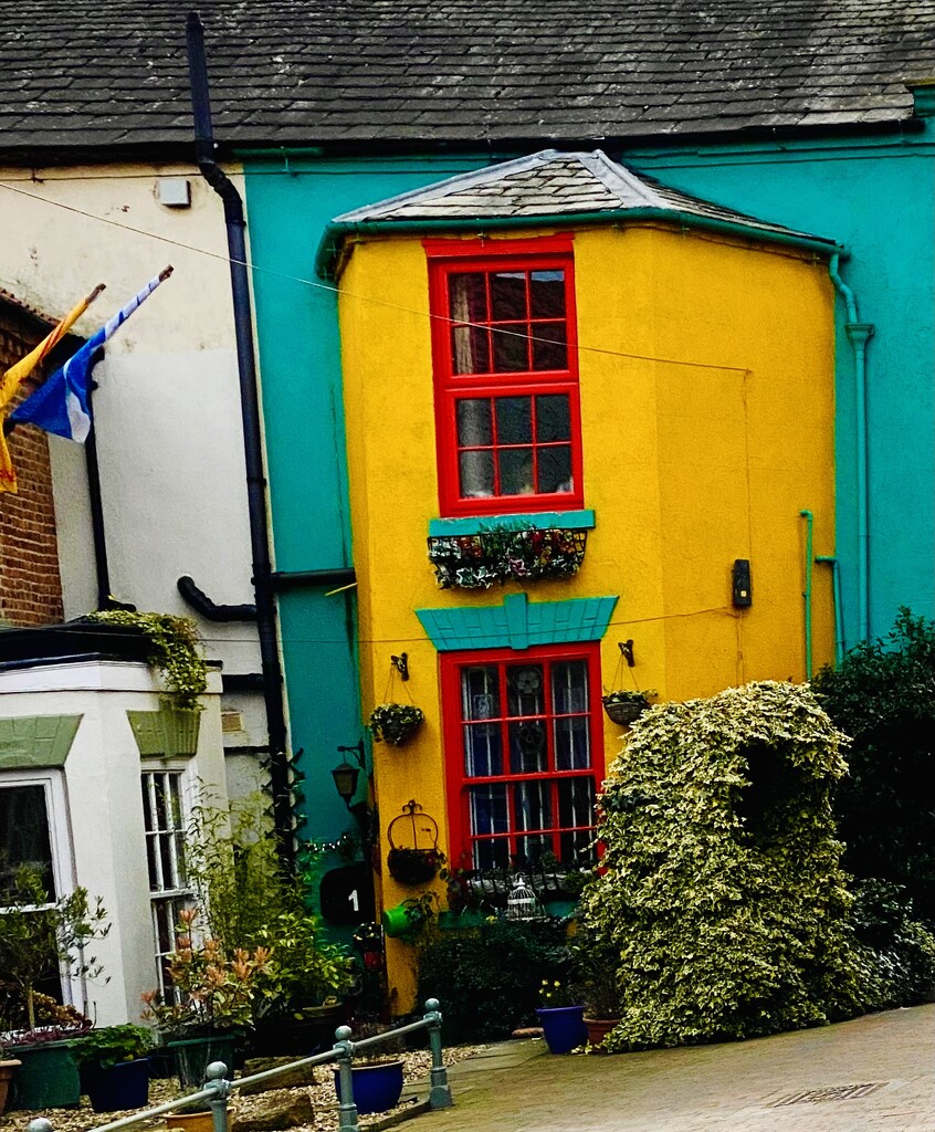 Colourful older terraced house by cafict
