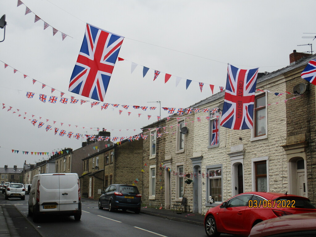 Union Flags and bunting from terraced houses. by grace55