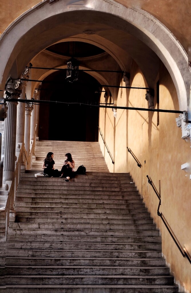 Chatting at sunset on the staircase  by caterina