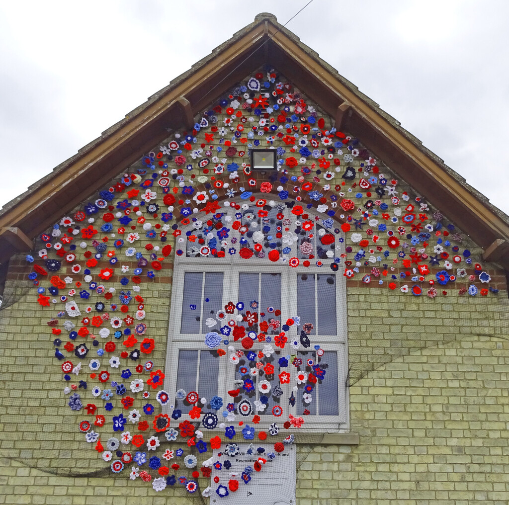 Crocheted flowers on Whaddon Village Hall by marianj