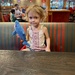 Lorelai in her booster seat at Red Robin.  by nicoleratley