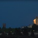 The rising of the supermoon behind the tower of the cathedral 