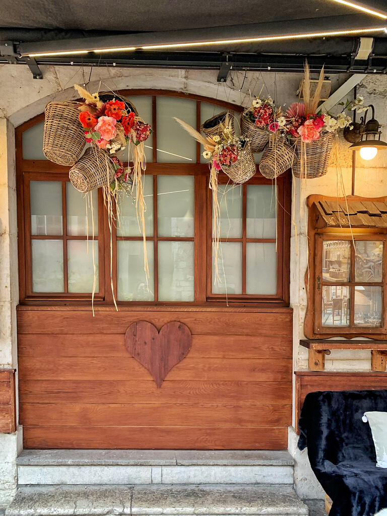 Wooden heart under the window.  by cocobella