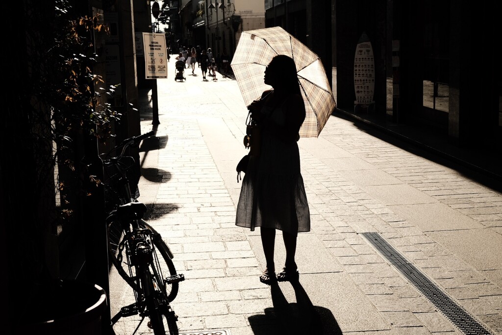 A girl walks alone in the sun by stefanotrezzi