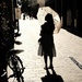 A girl walks alone in the sun by stefanotrezzi