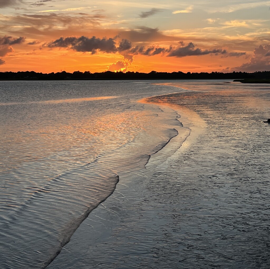 Sunset at low tide over the river by congaree