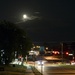 Hunter’s Moon over Busy Intersection  by metzpah