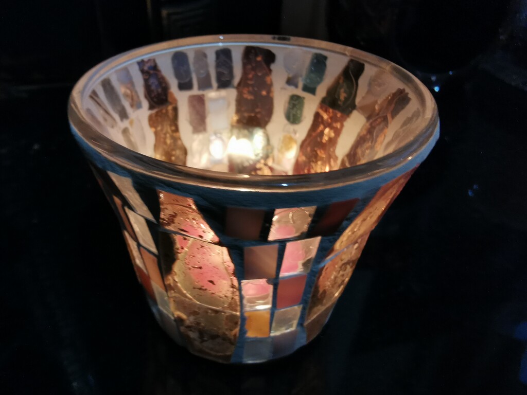 A lit tealight in a mosaiced holder  by plainjaneandnononsense