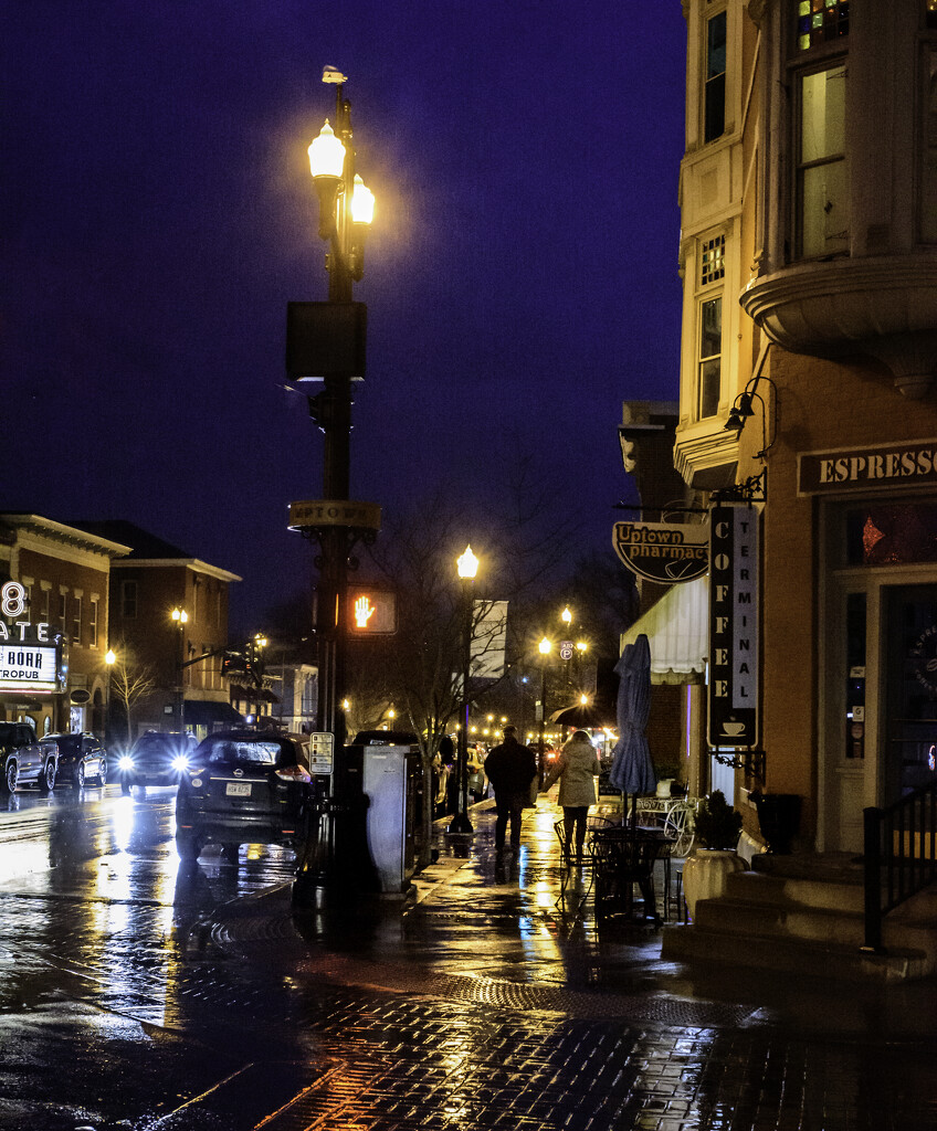 Couple's walk on a rainy night in uptown by ggshearron