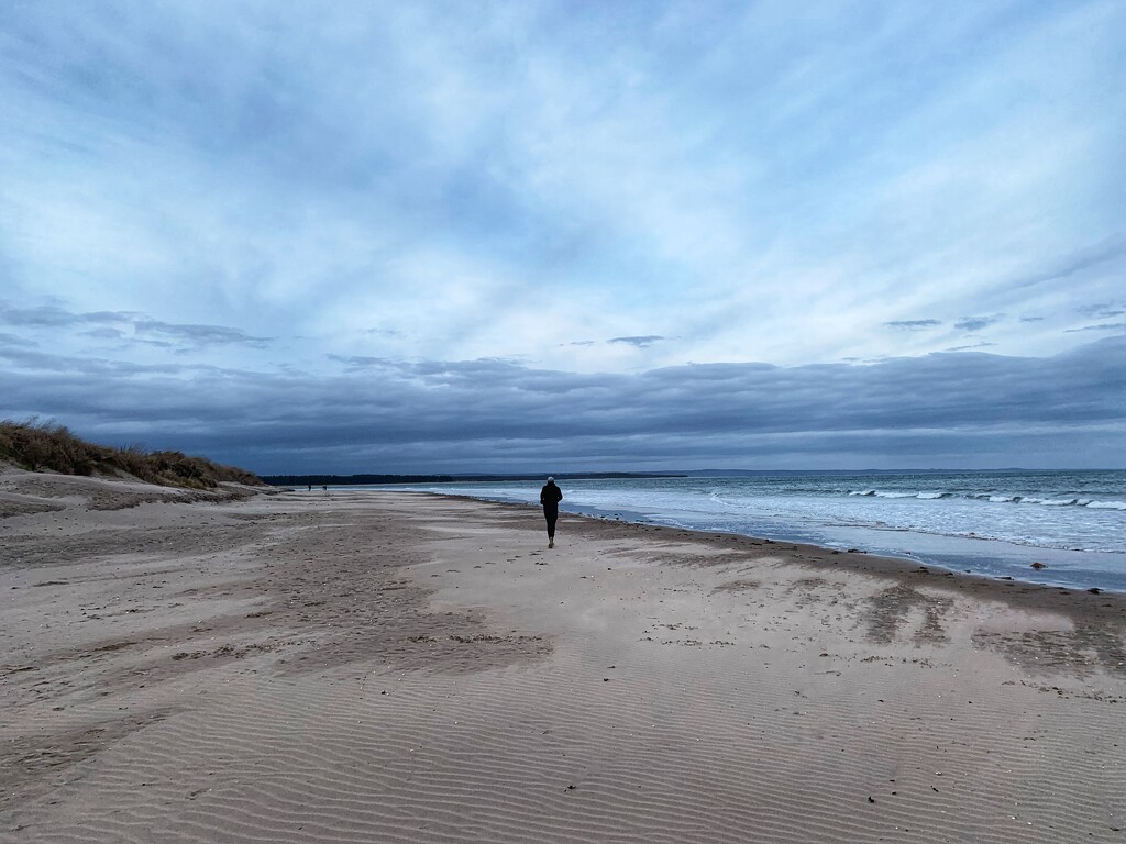 A jogger on the beach. by billdavidson