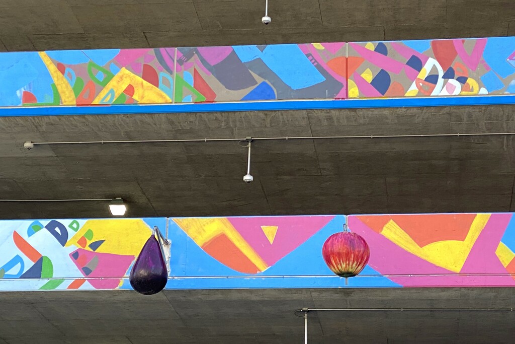 A parking garage with fruit and vegetable lights by tunia