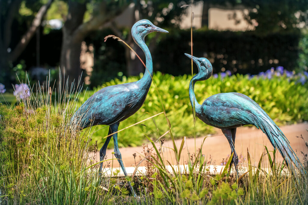 Blue Crane statues in a garden by ludwigsdiana