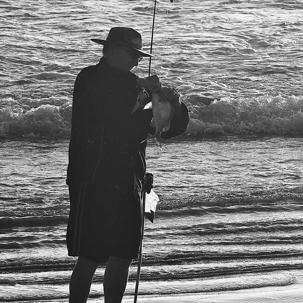 Up early incoming tide with his first catch  by Dawn