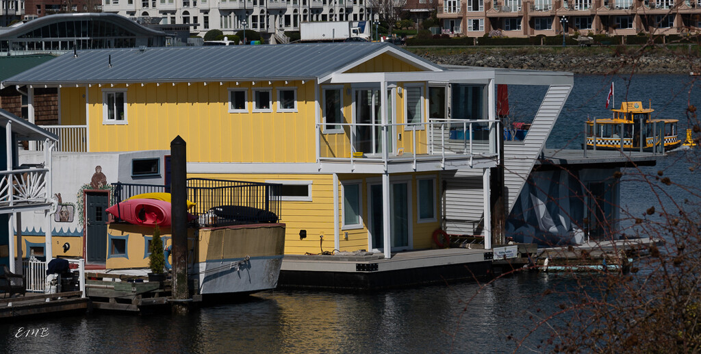 Yellow house boat and water taxi by theredcamera