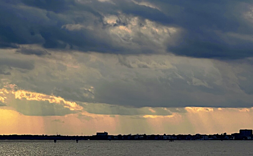 Cloud layers and sunbeams over the harbor  by congaree