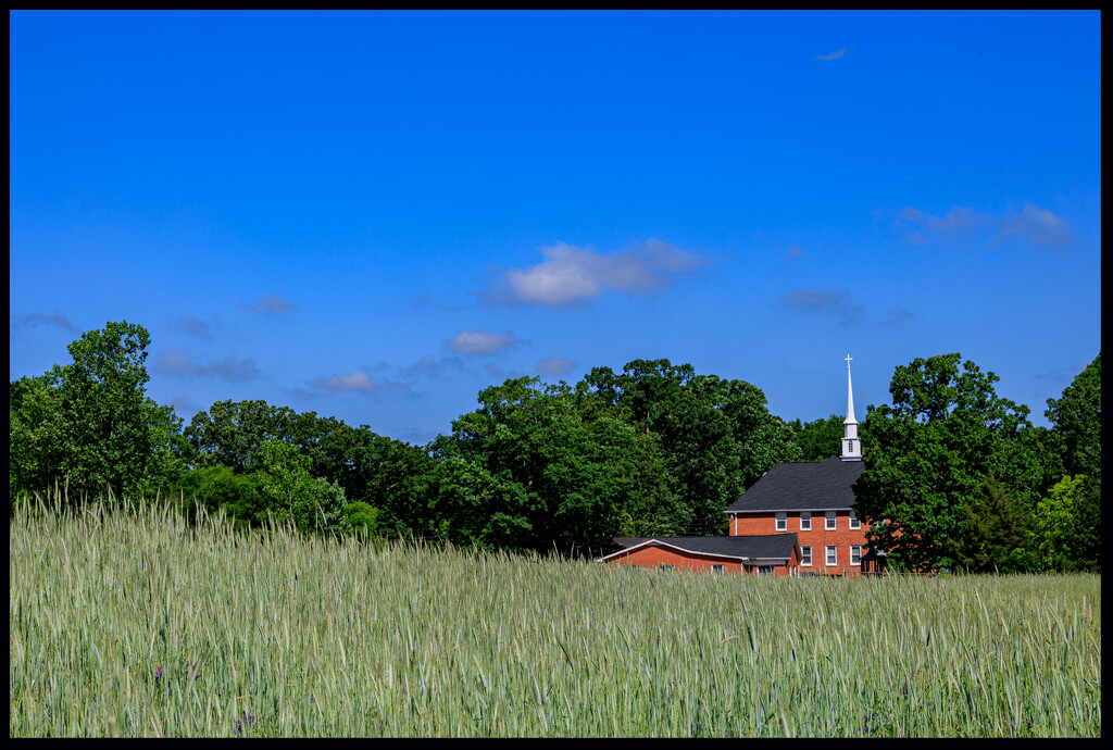 Greens, Blue, and a Church by hjbenson