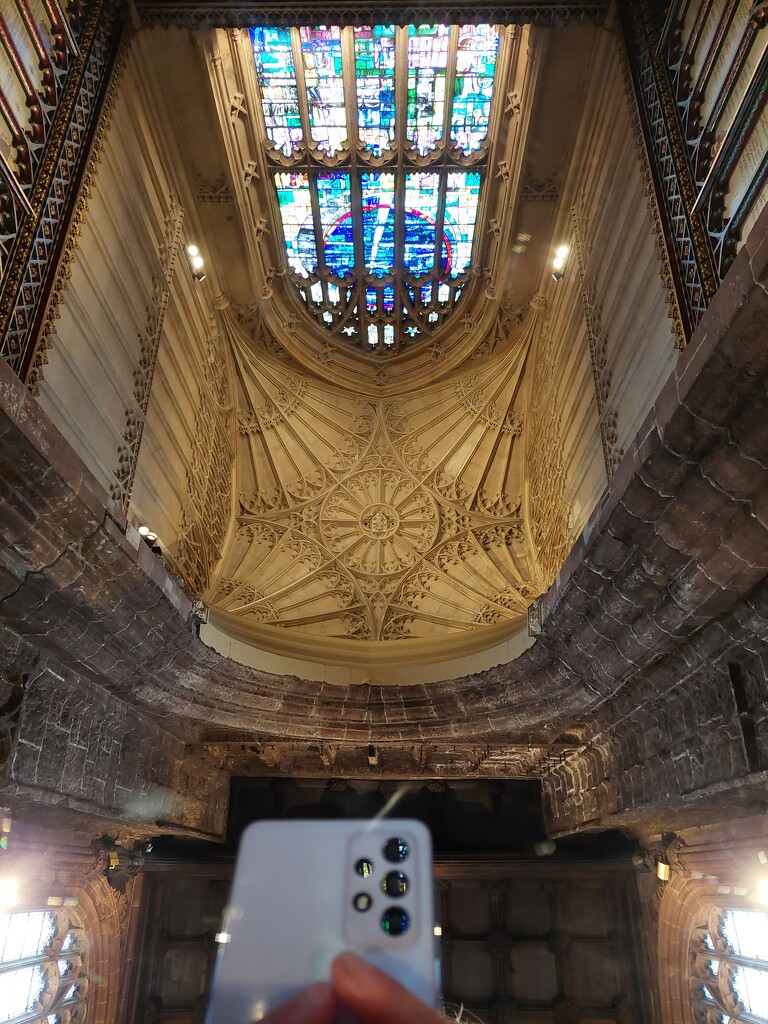 Taking a photo of the reflection in a large mirror of the stained glass window and ceiling in Manchester Cathedral  by samcat