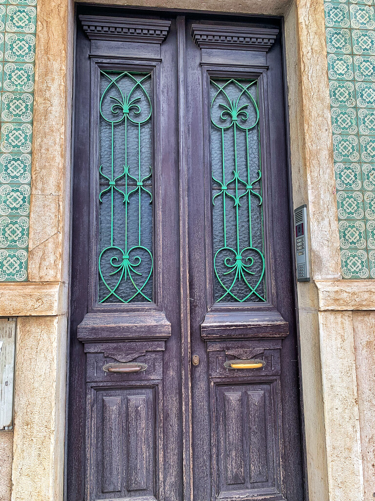 Four green hearts on burgundy door.  by cocobella