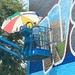 Filling in the letters of the mural by tunia