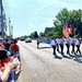 Spectators applaud as the United States flag goes by in the local July 4th parade by ggshearron