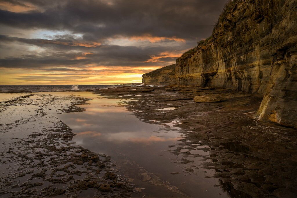 Sunset over the rock platform by pusspup