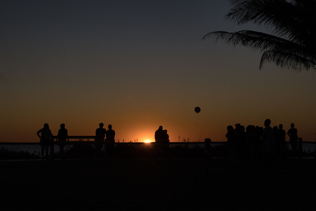 Sunset silhouettes with balloon by dkbarnett