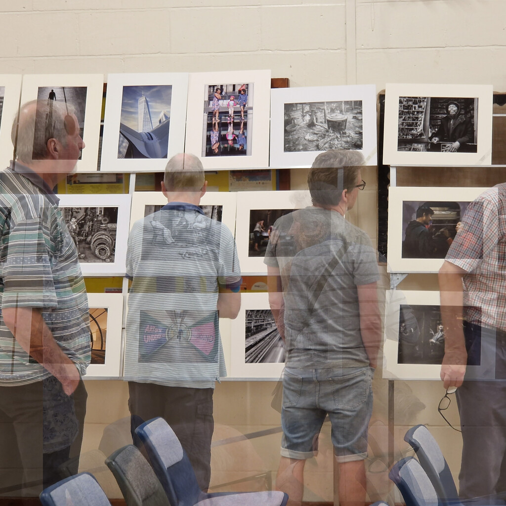 Admiring prints at camera club by andyharrisonphotos