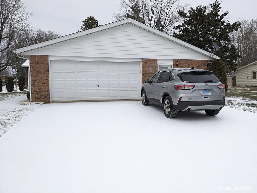 Car on snow in driveway by rhoing