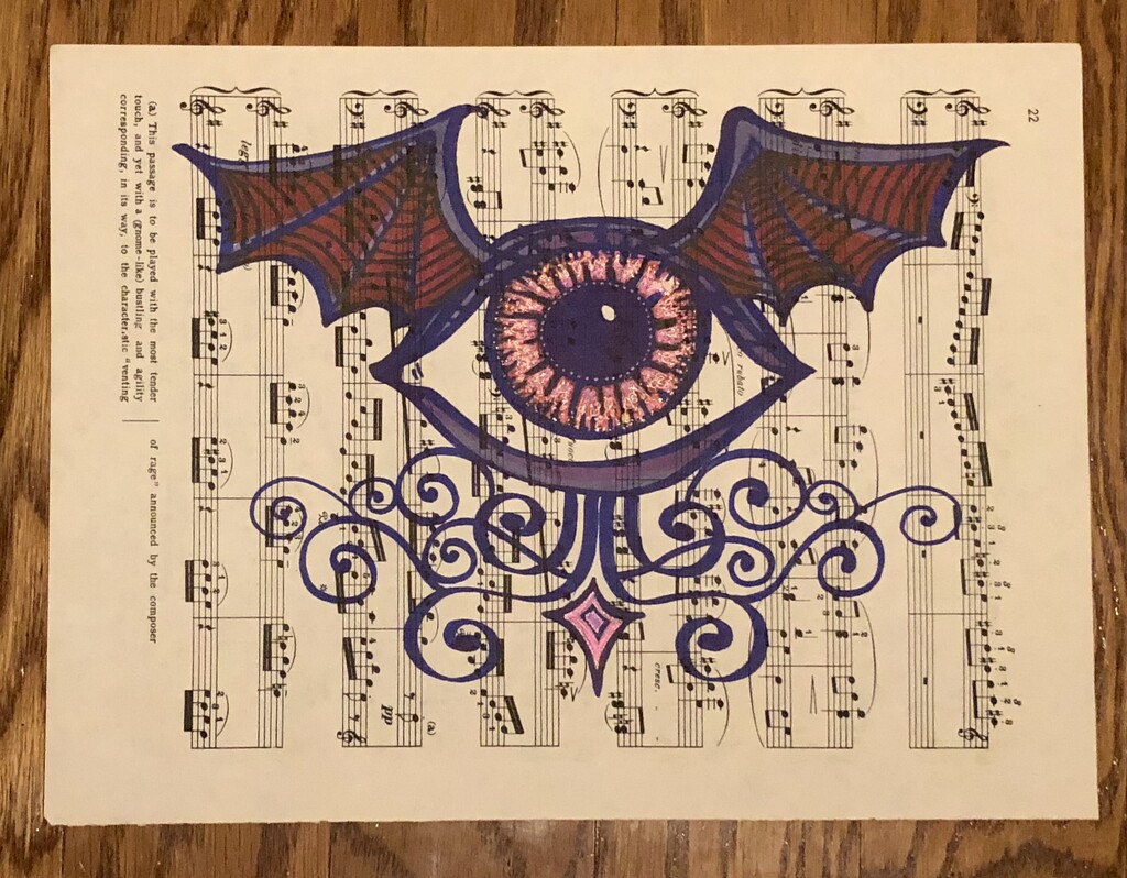 Winged eye drawing on sheet music by metzpah