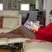 My wife checks out the recent AARP magazine while watching television by ggshearron