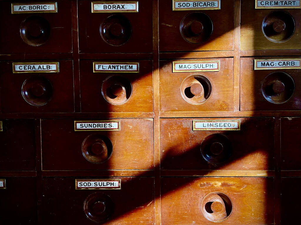 Shadows on the apothecary drawers by nigelrogers