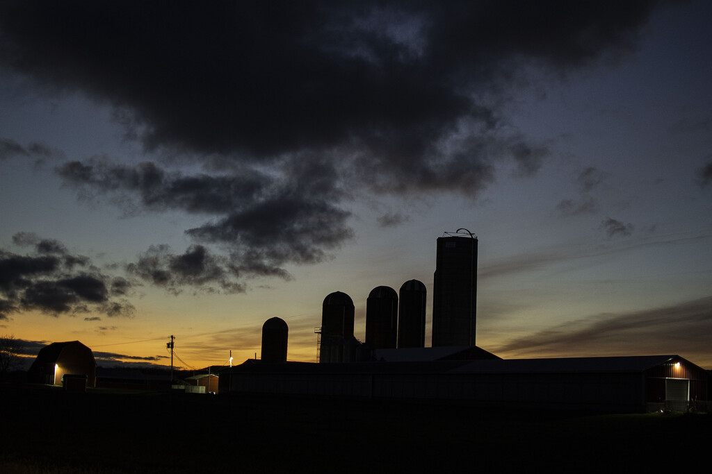 Sunrise behind the silos by darchibald